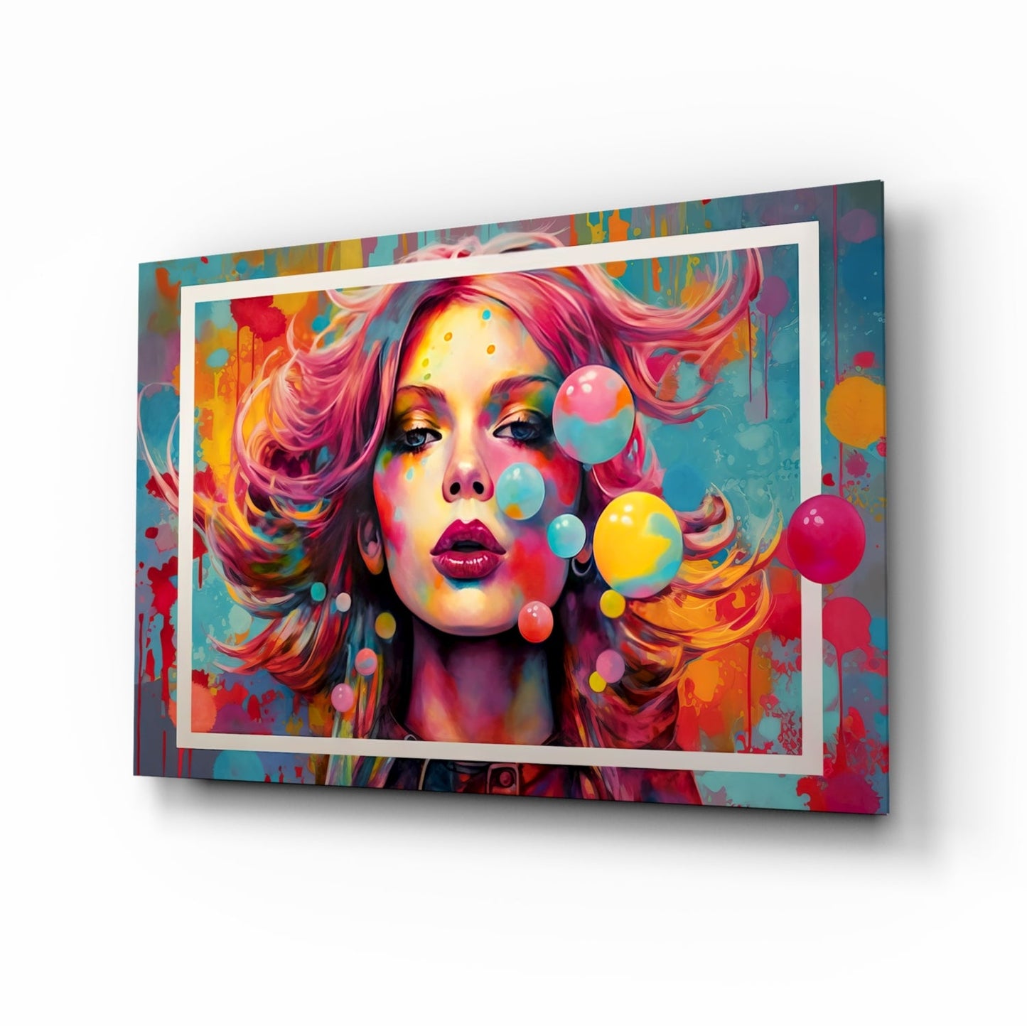 Angled view of colorful glass wall art featuring a woman's portrait with vibrant pink hair, rainbow-painted face, floating bubbles, and white frame border against multicolored abstract background.