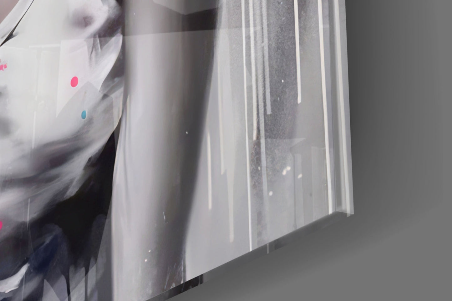 Close-up angled view of glass wall art showing vertical white streaks and colored dots (pink and blue) on translucent glass surface.