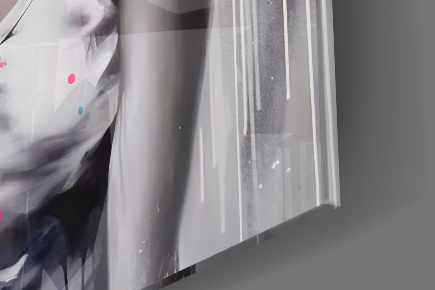 Close-up angled view of glass wall art showing vertical white streaks and colored dots (pink and blue) on translucent glass surface.