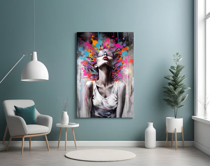 Modern living room with turquoise walls featuring colorful abstract portrait glass art above white chair and potted plants.