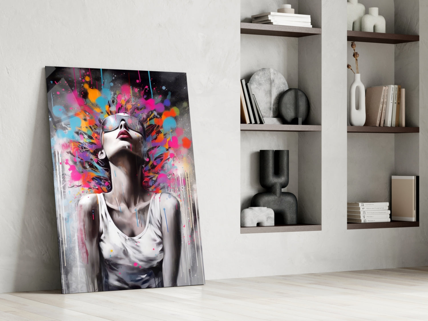 Colorful glass wall art leaning against white wall beside built-in shelving with decorative objects and books.