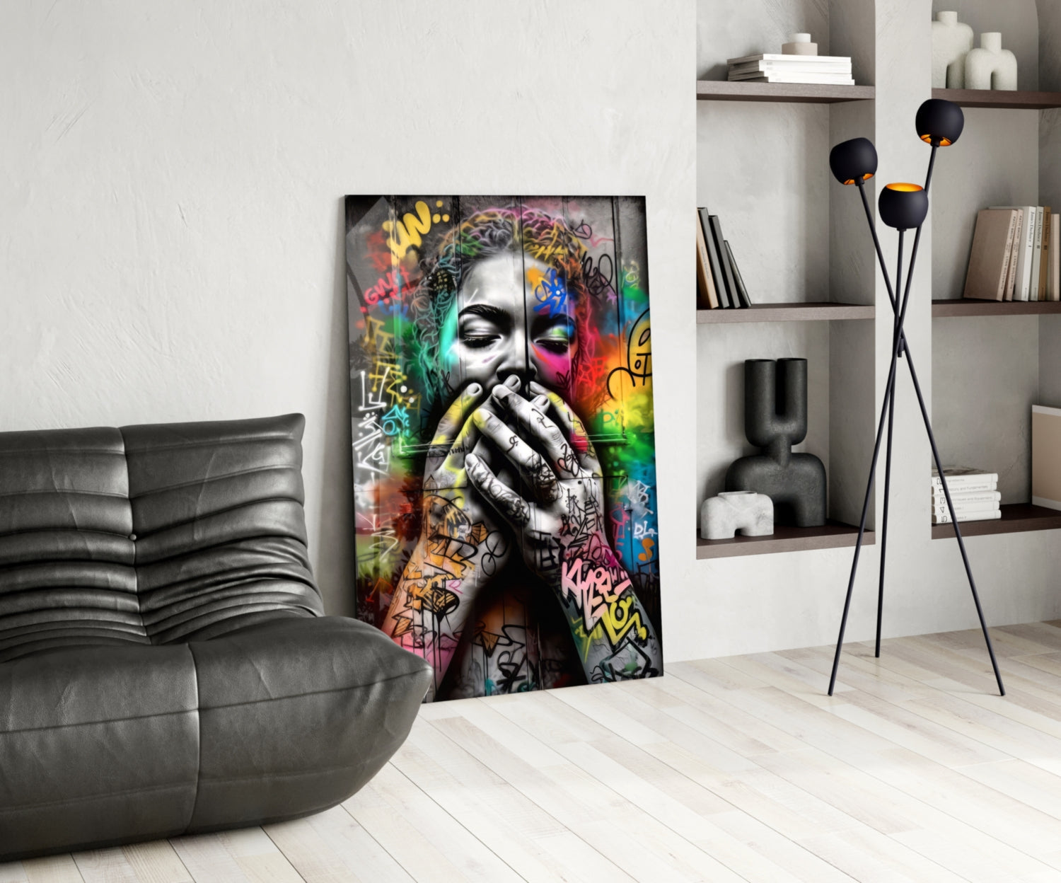 Colorful street art portrait on glass panel displayed in modern living room with grey sofa and shelving.