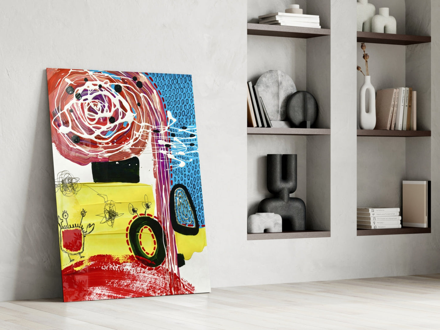 Colorful glass wall art leaning against white wall beside shelving unit, featuring red, yellow, and blue abstract design with vehicle motif.