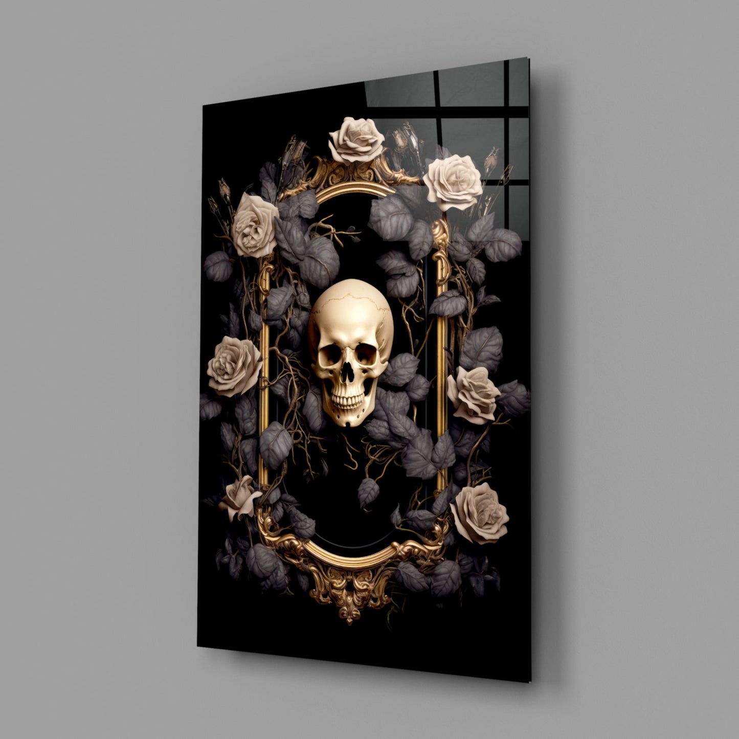 Angled view of black glass wall art displaying a cream skull surrounded by dark flowers, gold ornamental frame, and gold vertical elements against gray background.