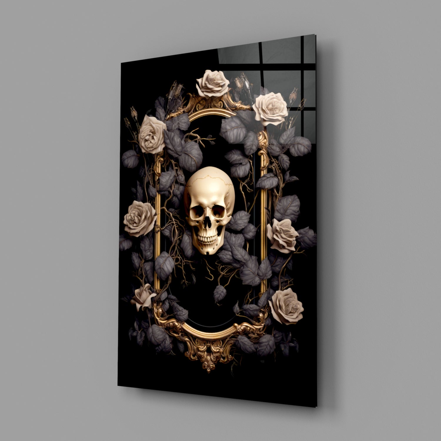 Angled view of black glass wall art displaying a cream skull surrounded by dark flowers, gold ornamental frame, and gold vertical elements against gray background.