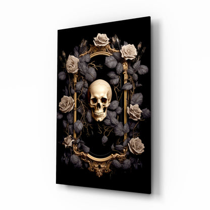 Angled perspective of glass wall art displaying a cream skull centered within an ornate gold frame, surrounded by dark foliage and pale roses against black background.