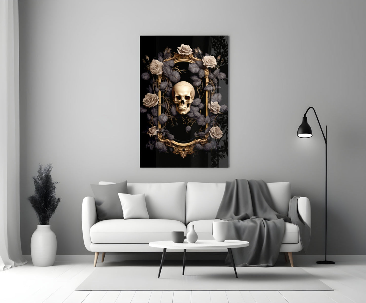 Gold-framed skull artwork surrounded by cream and grey roses on black background, displayed above white sofa in modern living room.