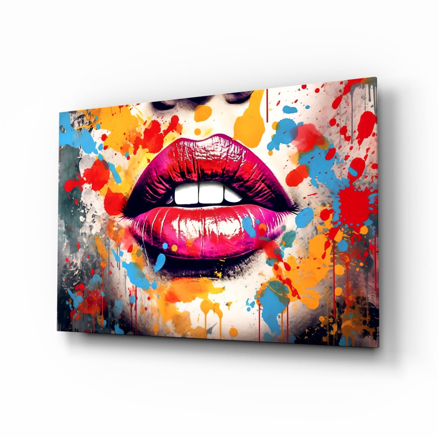 Red lip glass wall art displayed at an angle showing vibrant splattered paint in red, blue, yellow, and orange on a neutral background.