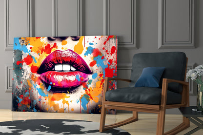 Colorful pop art glass wall panel featuring vibrant magenta lips with paint splatters displayed in modern living room setting.