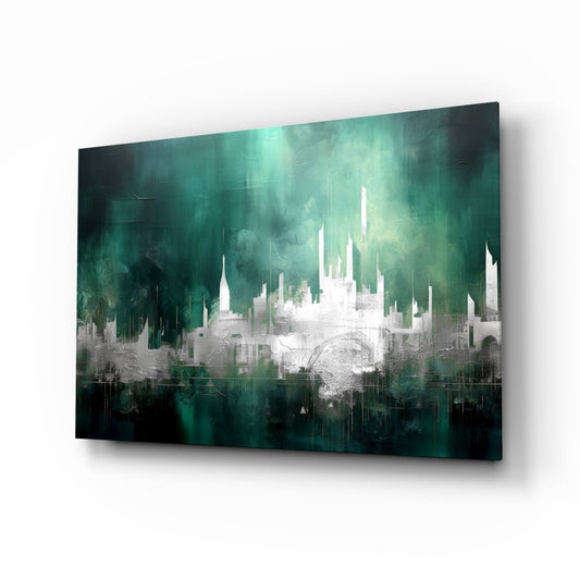 Angled view of glass wall art featuring white cityscape silhouette against deep teal and emerald gradient background with dripping effect.
