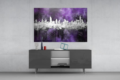 Purple and white cityscape glass wall art displayed above a dark gray media console in a modern living room setting.