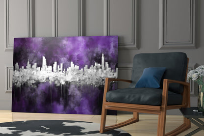Purple and white cityscape glass art panel displayed in modern living room with mid-century wooden chair and paneled wall.