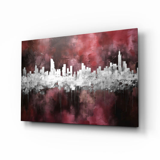 Angled perspective of burgundy and white glass wall art featuring a cityscape silhouette with dripping effect against textured background.