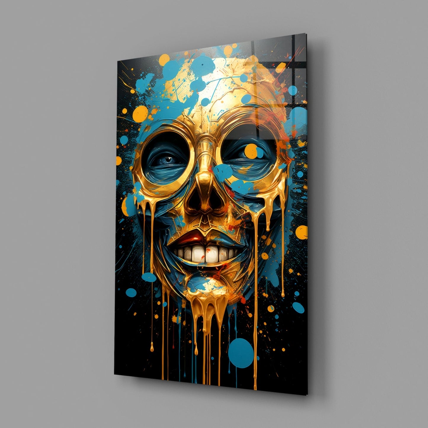 Golden skull with blue and orange dripping paint effects mounted on gray wall, angled view showing depth.