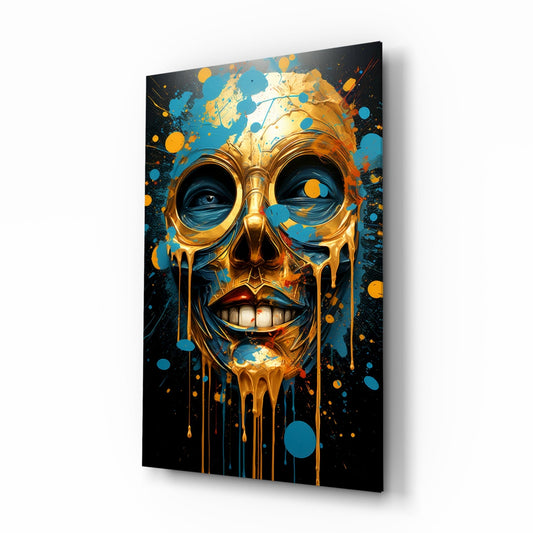 Gold and blue glass skull wall art with dripping effect displayed at an angle against white background.