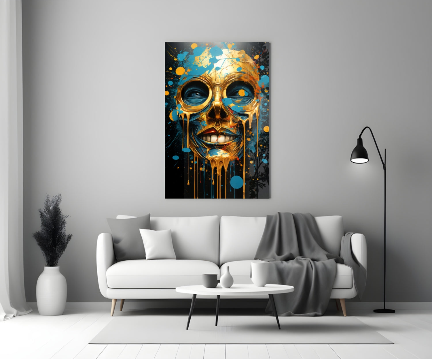 Golden skull with blue splashes hanging above white sofa in minimalist living room setting.