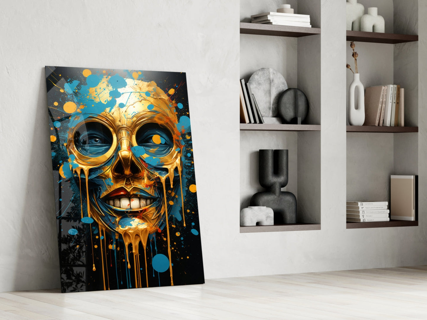 Gold and blue melting skull artwork leaning against white wall beside shelving with decorative objects.