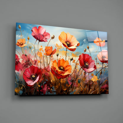 Glass wall art panel displaying a field of red, pink, and orange poppies against a blue sky, mounted at an angle on gray wall.
