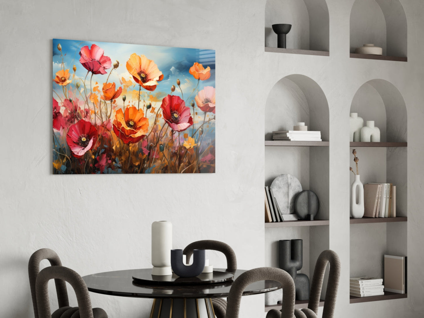 Colorful poppy field glass wall art hanging above a black round dining table with gray chairs and white shelving unit.