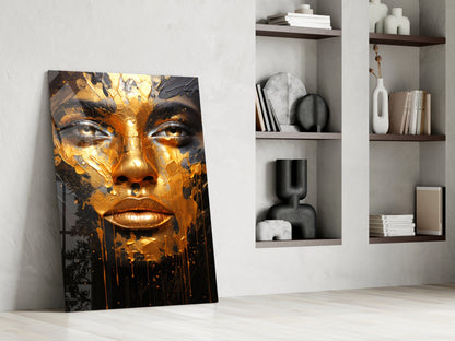 Golden Melt Glass Wall Art leaning against white wall next to shelving unit displaying decorative objects and books.