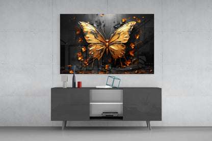 Golden butterfly glass wall art with orange fire effects displayed above dark gray TV console in modern living room interior.