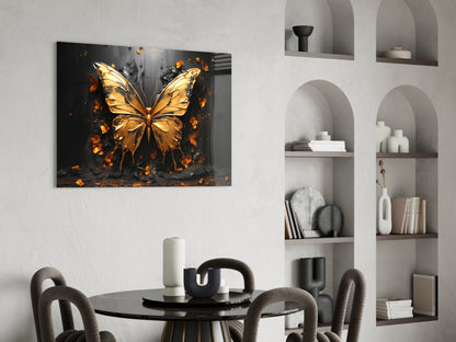 Golden butterfly with orange splatter effect on black background, displayed above dining table in modern interior setting.
