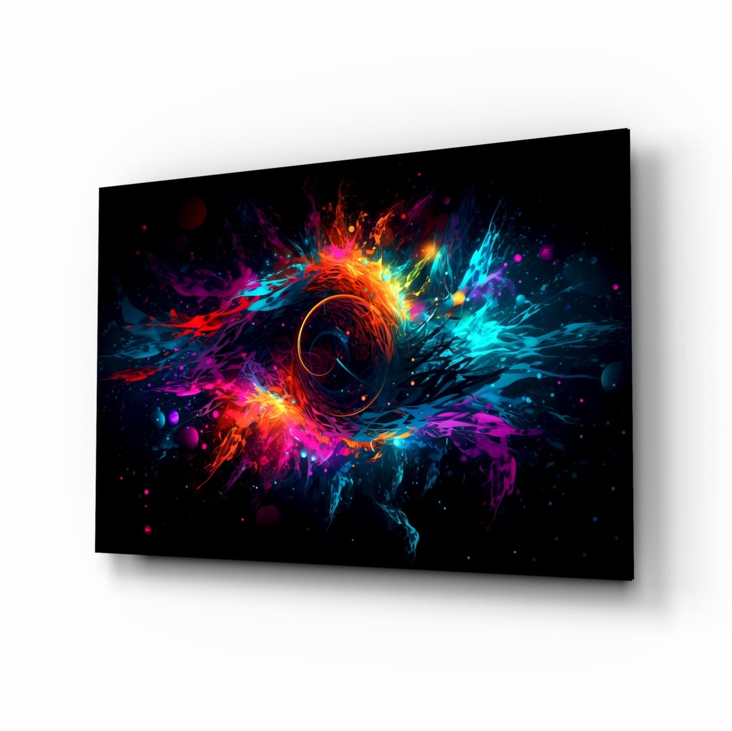 Angled perspective of black glass wall art panel displaying vibrant multicolored explosion with central circular hole, surrounded by neon red, blue, cyan, and magenta bursts.