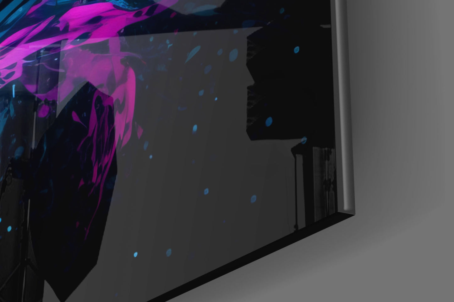 Silhouetted figure viewing vibrant magenta and blue abstract glass wall art installation in modern interior space.