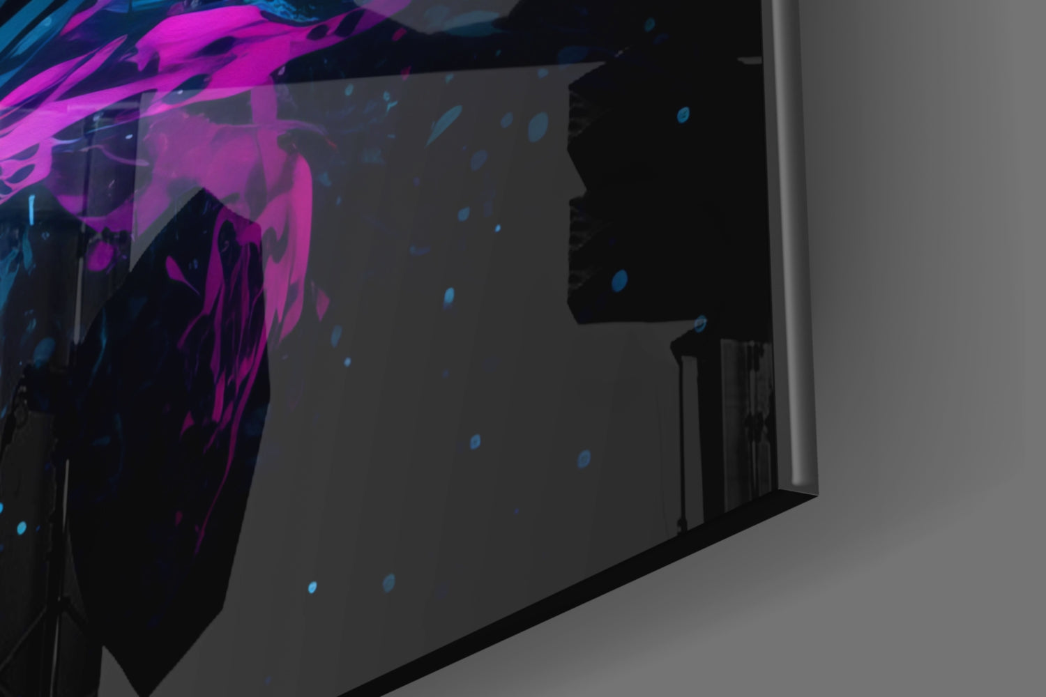 Silhouetted figure viewing vibrant magenta and blue abstract glass wall art installation in modern interior space.