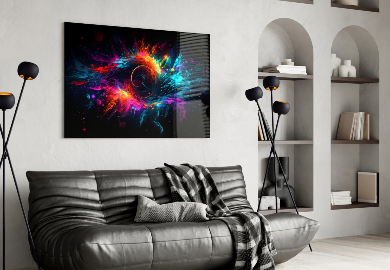 Colorful abstract glass wall art with vibrant neon pink, blue, and orange explosion design displayed above gray leather sofa in modern living room setting.