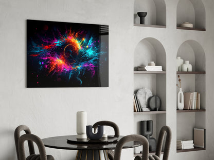 Colorful Hole Glass Wall Art mounted above a round black dining table with gray chairs, displaying vibrant neon orange, pink, cyan, and purple explosion design on black background.