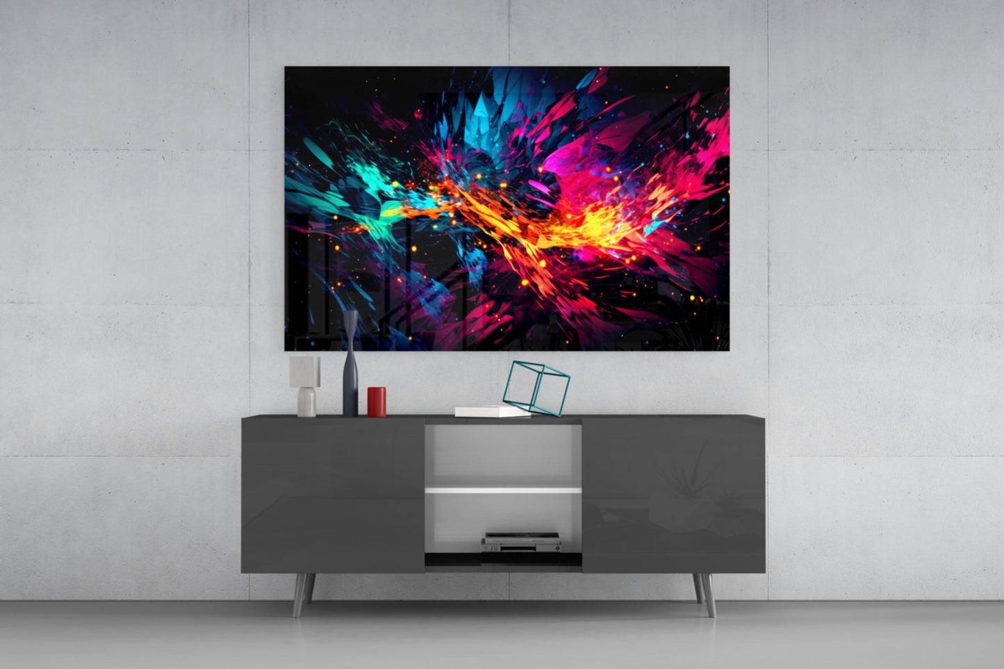 Colorful abstract glass wall art with cyan, magenta, yellow, and orange bursts displayed above a dark gray TV console in a modern living room setting.