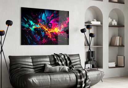 Vibrant multicolored abstract glass art with blue, pink, yellow, and cyan explosion pattern displayed above gray leather sofa in modern living room interior.