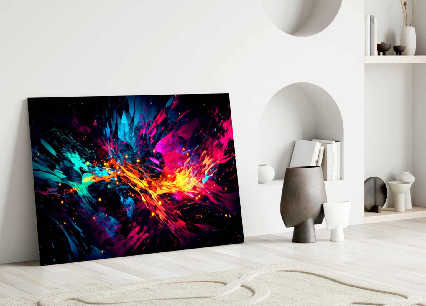 Vibrant glass wall art leaning against white wall displaying explosive cyan, magenta, and yellow abstract burst pattern on black background.