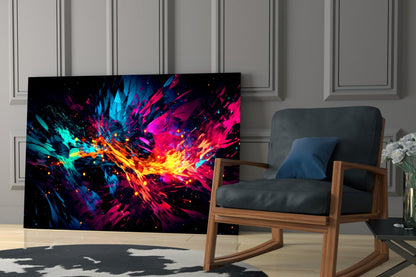 Vibrant colorful glass wall art displaying explosive cyan, magenta, and yellow energy bursts displayed in modern living room setting.
