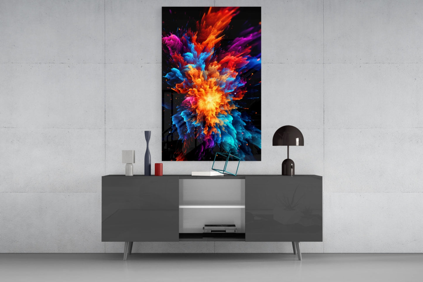 Colorful abstract explosion artwork displayed on white wall above modern gray media console with decorative items.
