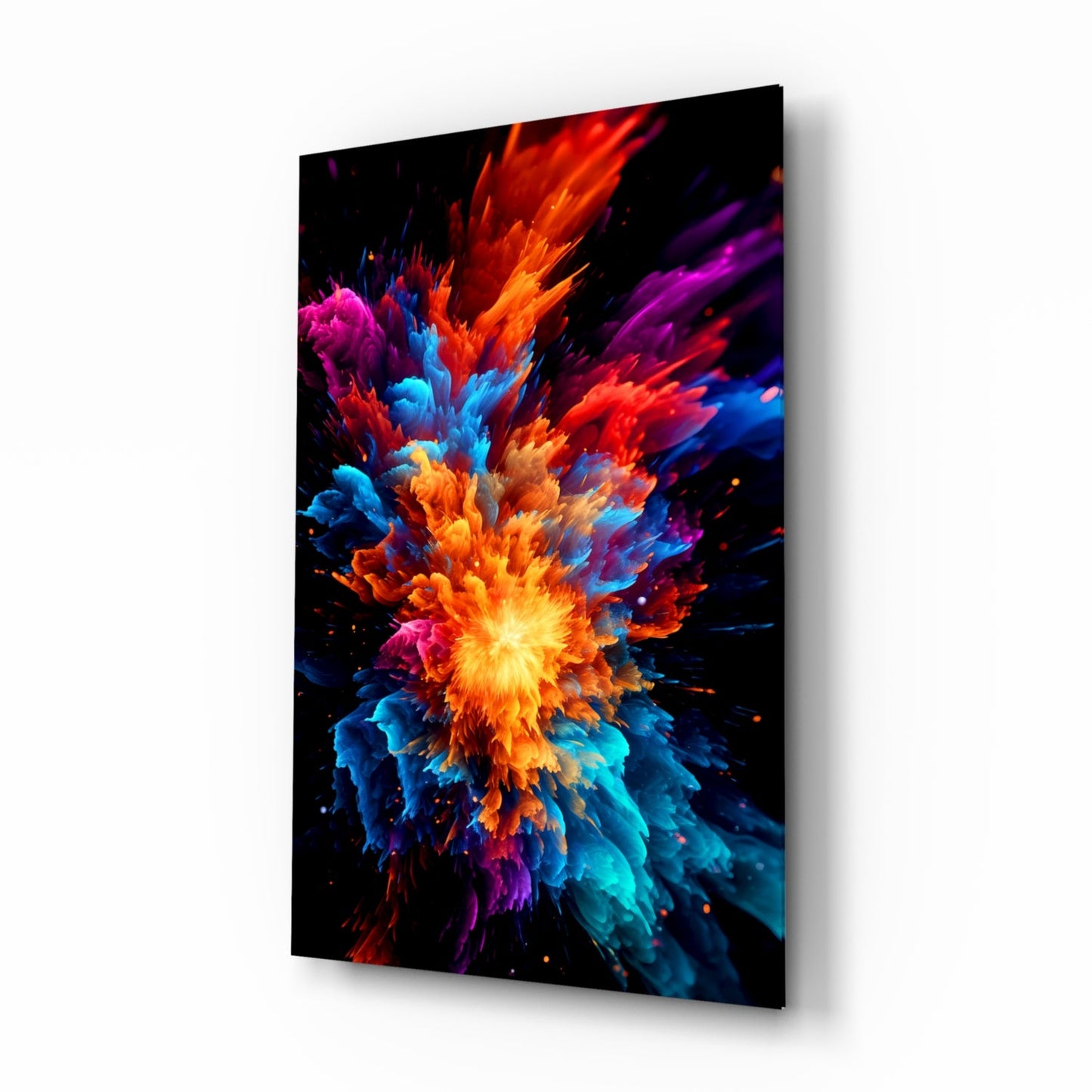 Angled perspective view of a glass wall art panel displaying a vibrant color explosion with yellow center and radiating red, orange, blue, purple, and cyan bursts against black background.