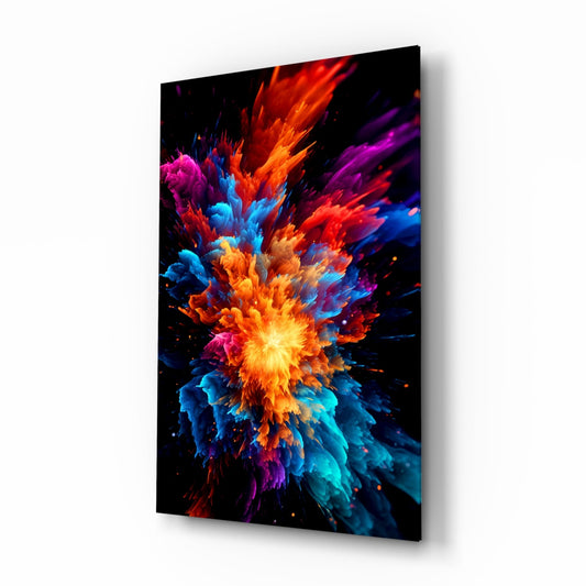 Angled perspective view of a glass wall art panel displaying a vibrant color explosion with yellow center and radiating red, orange, blue, purple, and cyan bursts against black background.