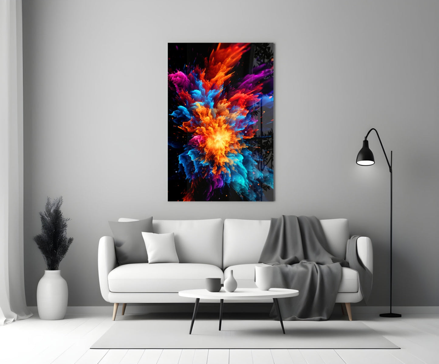 Colorful glass wall art with vibrant red, orange, blue, and purple explosion design mounted above white sofa in modern living room.