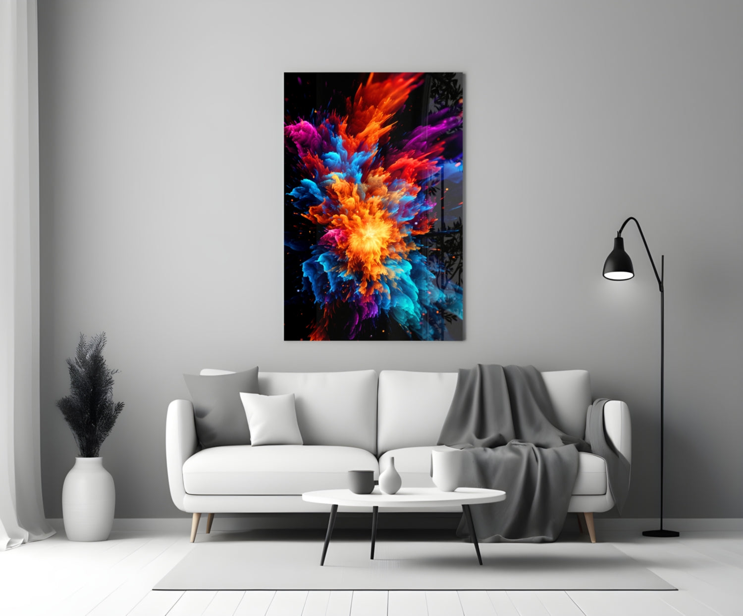 Colorful glass wall art with vibrant red, orange, blue, and purple explosion design mounted above white sofa in modern living room.