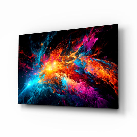 Glass wall art panel displayed at an angle showing a vibrant blue, orange, and magenta starburst explosion with bright yellow center on black background.