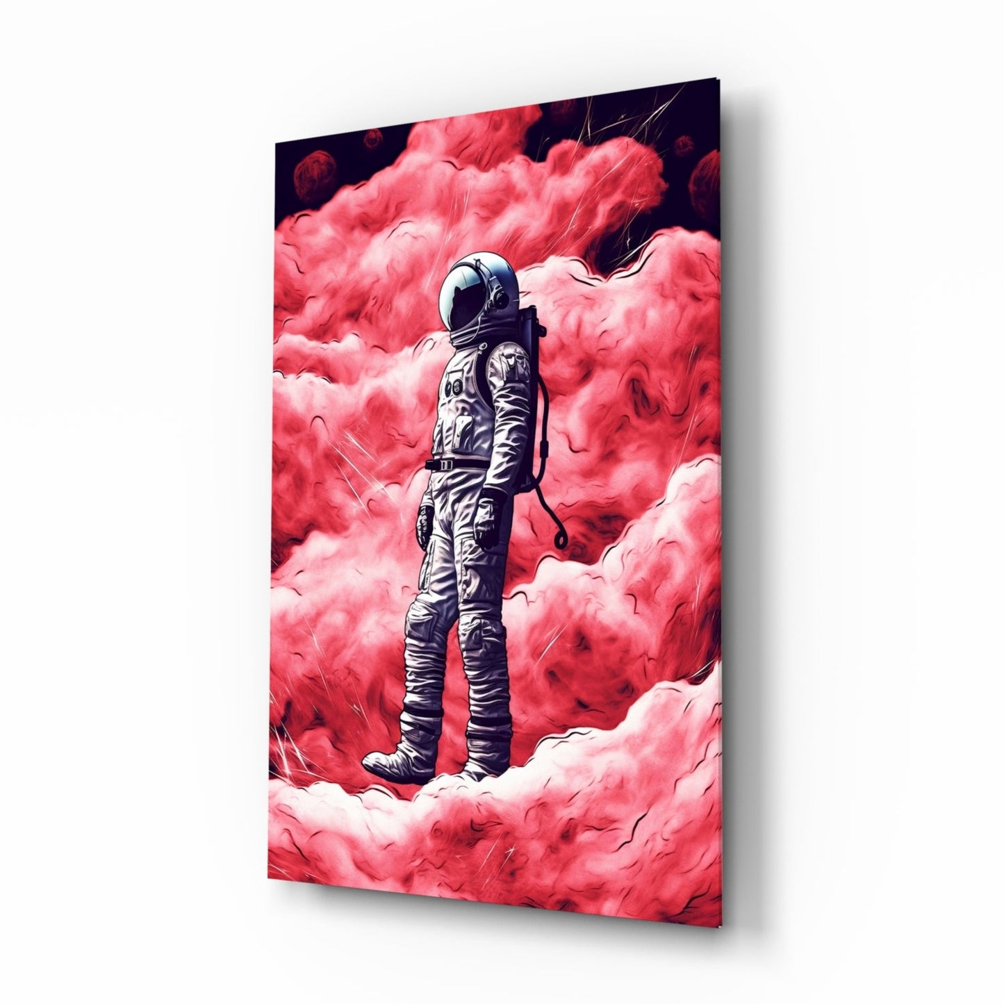 Angled perspective of glass wall art displaying a suited astronaut figure centered against vivid pink and red cloudy atmosphere.