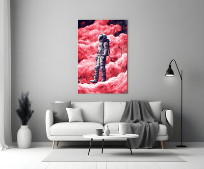 Glass wall art depicting an astronaut in spacesuit standing on a vibrant pink cloudy landscape, displayed above a white sofa in a modern living room.