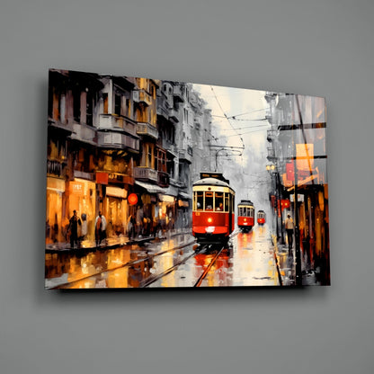 Red and yellow tram moving through wet city street with illuminated buildings and overhead wires on glass wall art panel.
