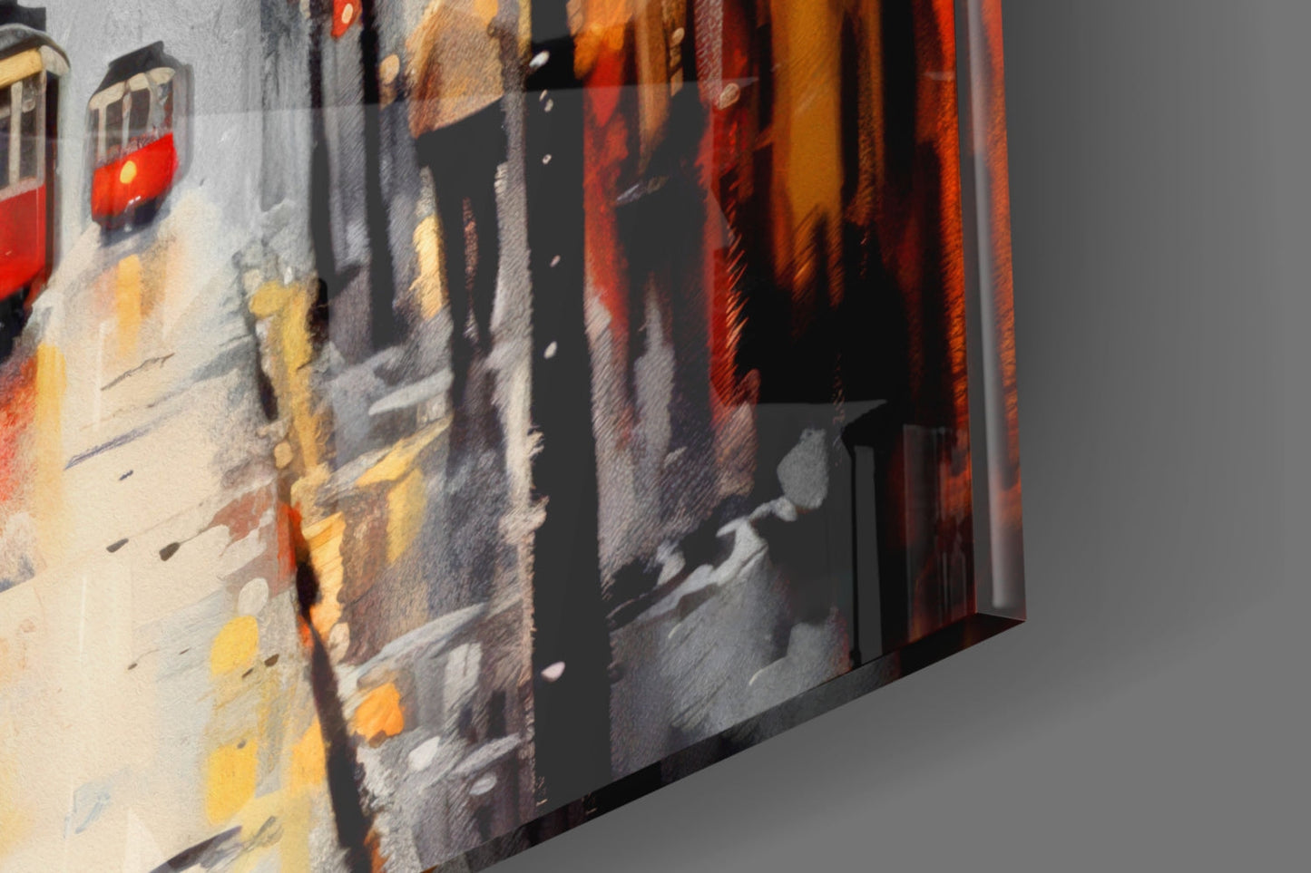 Angled side view of glass wall art depicting a snowy European street scene with warm yellow and red building lights, printed on textured glass surface.