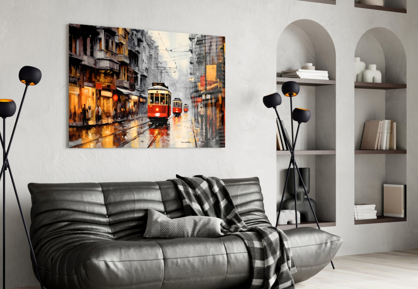 Red tram street scene glass artwork displayed above black leather sofa in modern living room interior.