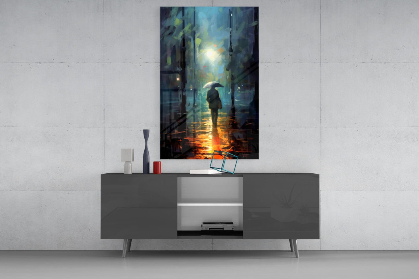 Modern living room with dark console table displaying rainy street scene glass wall art above, featuring silhouetted figure with umbrella.
