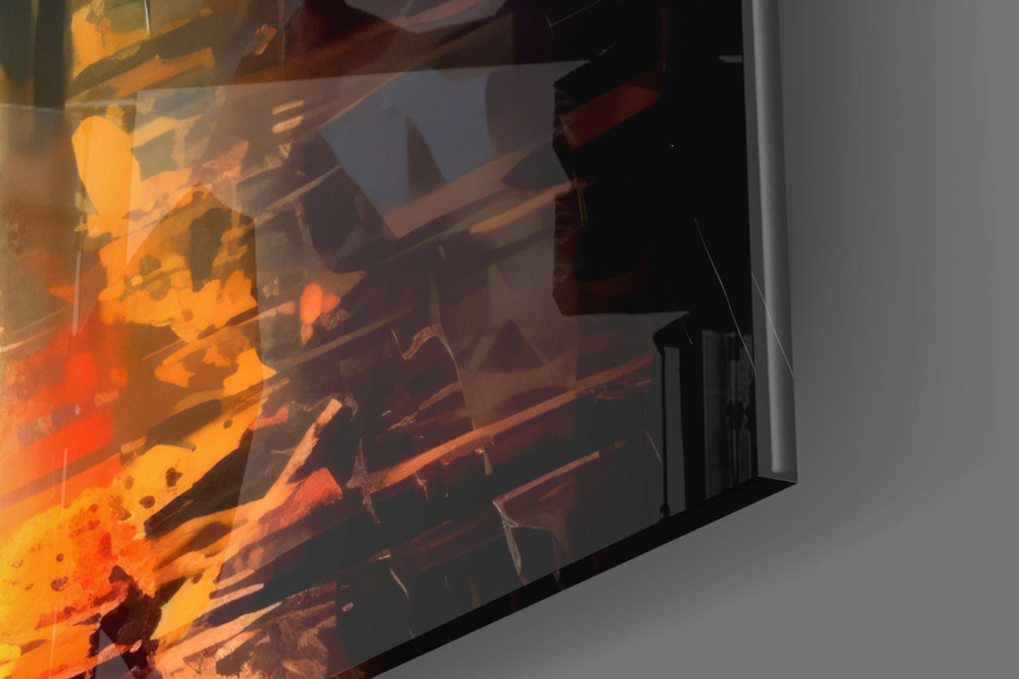 Close-up angled view of glass wall art displaying vibrant orange and red flame artwork against gray wall background.