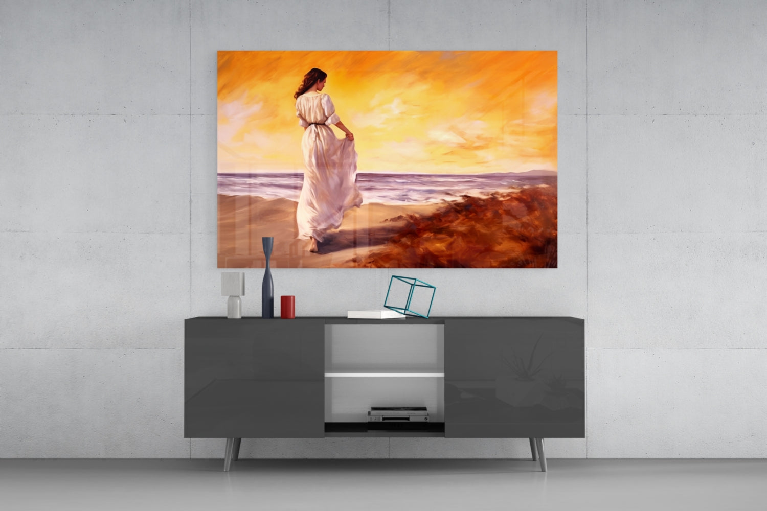 Glass wall art depicting a woman in a white dress on a beach at sunset, displayed above a dark modern media console.