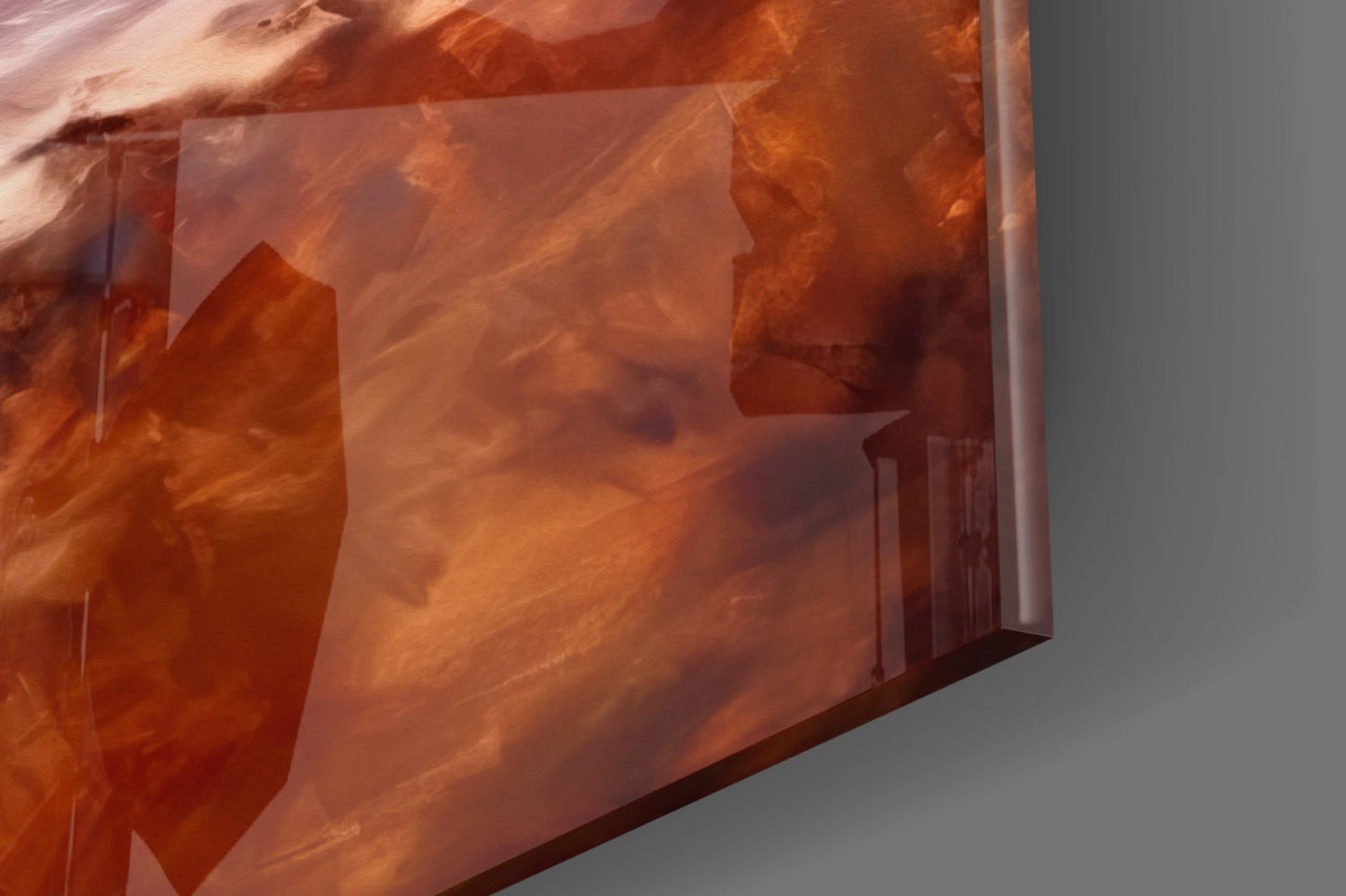Close-up angled view of translucent amber resin wall art with layered architectural forms and warm orange tones against neutral background.